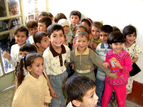 Photograph of school children in Iraq, taken by an American soldier of C Co, 1/252 Army Reserve Battalion.  Logo for the M203.com presentation entitled School.