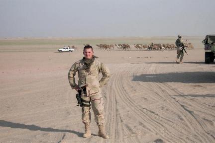 Photograph of an American soldier in the desert of Iraq, taken by an American soldier of C Co, 1/252 Army Reserve Battalion . Logo for the M203.com presentation entitled Sand.