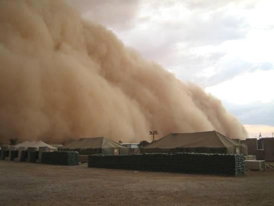 Photograph of a sand storm in Al Asad, Iraq as it is about to engulf tents, taken by an unidentified American soldier.