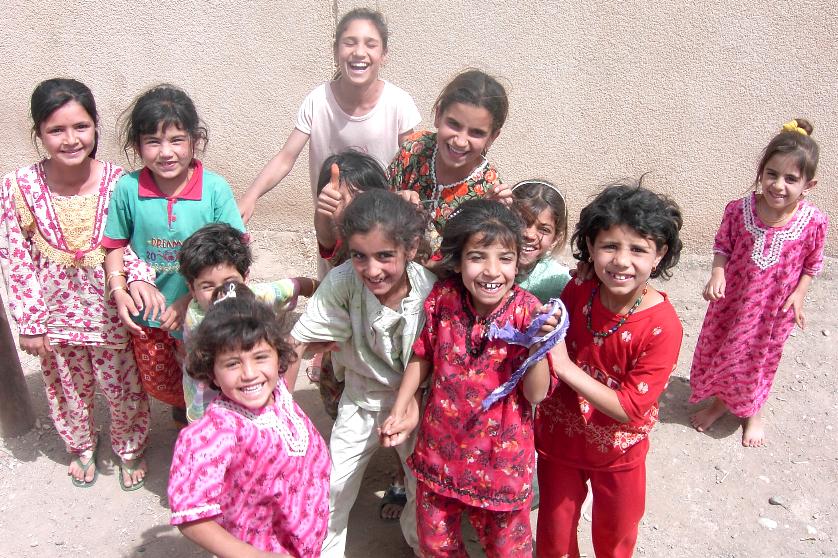 Photograph of Iraqi girls with huge smiles. Photograph by an American soldier of C Co, 1/252 Army Reserve Battalion. 