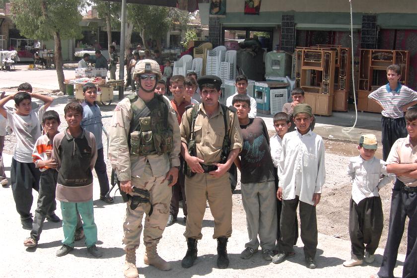 Photograph of an American soldier standing within a crowd of Iraqi people. Photograph by an American soldier of C Co, 1/252 Army Reserve Battalion.